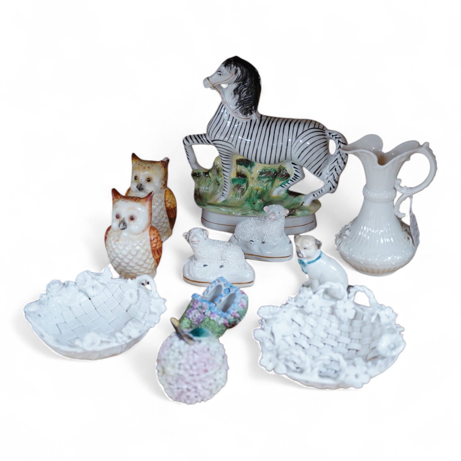 A pair of Worcester 'owl' candle snuffers, Staffordshire Zebra and two sheep, Belleek etc zebra 19cm wide.